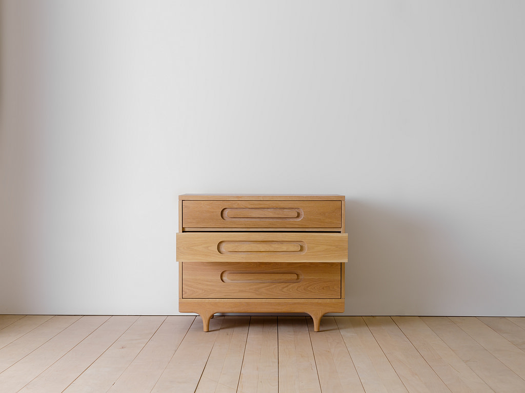 Kalonstudios caravan dresser naturalfinish 05 Caravan Dresser in White Oak with the Middle Drawer Pulled Out Front View on a Maple Plank Floor Against a Grey Wall