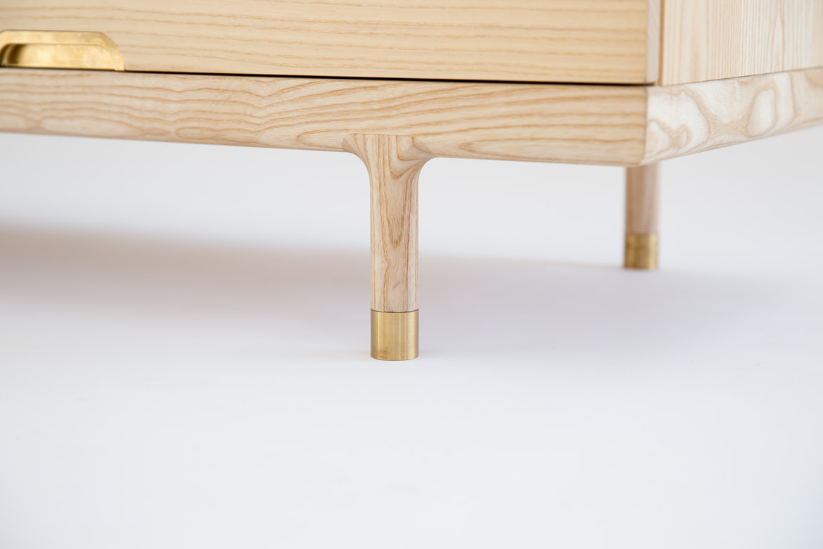 Simple Dresser detail of foot solid ash and brass