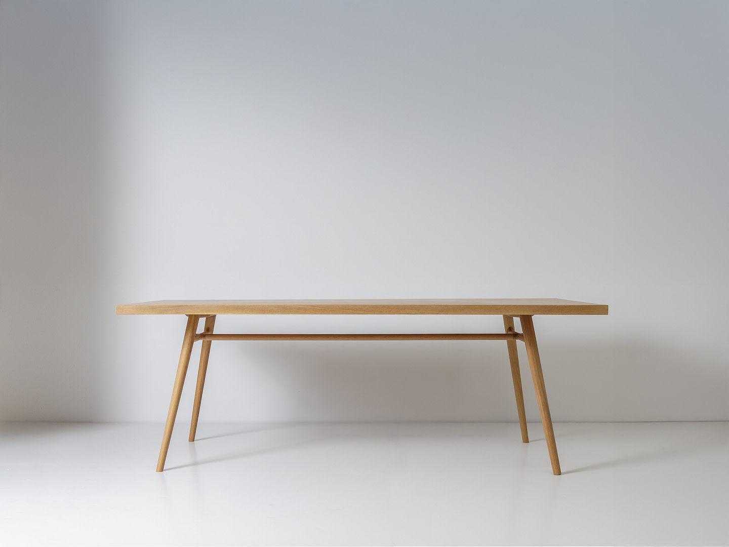 Kalon boughtableone whiteoak 01 Bough Table in White Oak Front View on a White Studio Floor Splayed Turned Legs Joined by a Low Cross stretcher