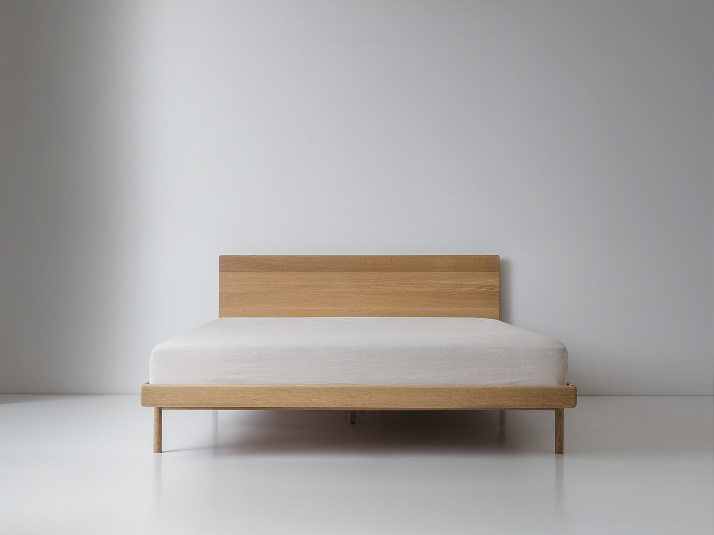 Kalon whiteoak simplebed queen Simple Bed in White Oak with Panel Headboard and White Mattress Plain Wood Legs Centered Low Symmetric View White Floor