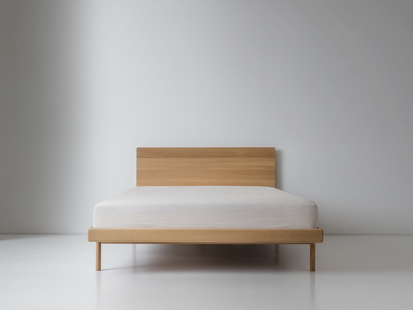 Kalon whiteoak simplebed full Simple Bed in White Oak with Panel Headboard and White Mattress Plain Wood Legs Centered Front Wider King Framing