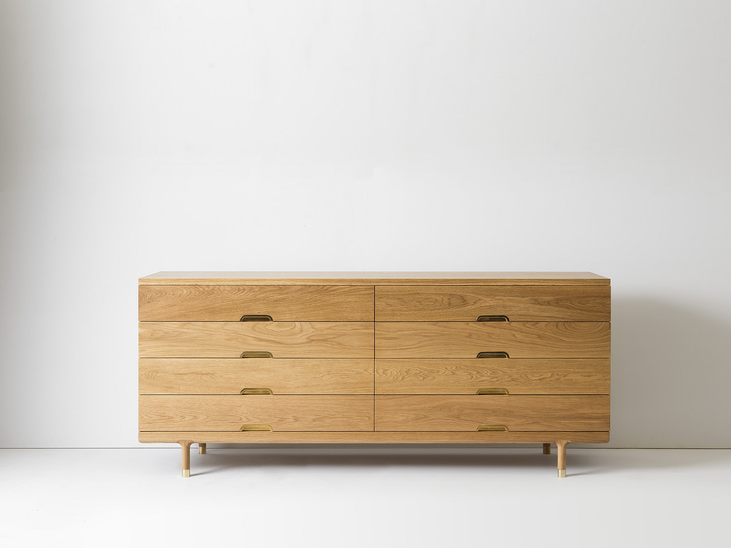 Wooden Dresser with Six Drawers and Brass Handles Against a White Wall in a Minimal Room Setting |  | Kalon Studios Us