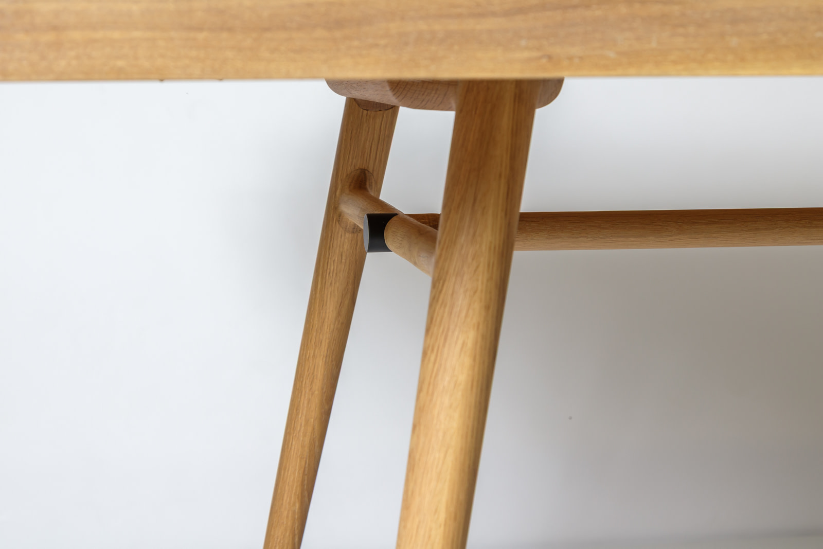 Kalon boughtableone whiteoak 06 Bough Table Close up in White Oak Blackened Steel Sleeve Clamping the Turned Cross stretcher to the Trestle Legs