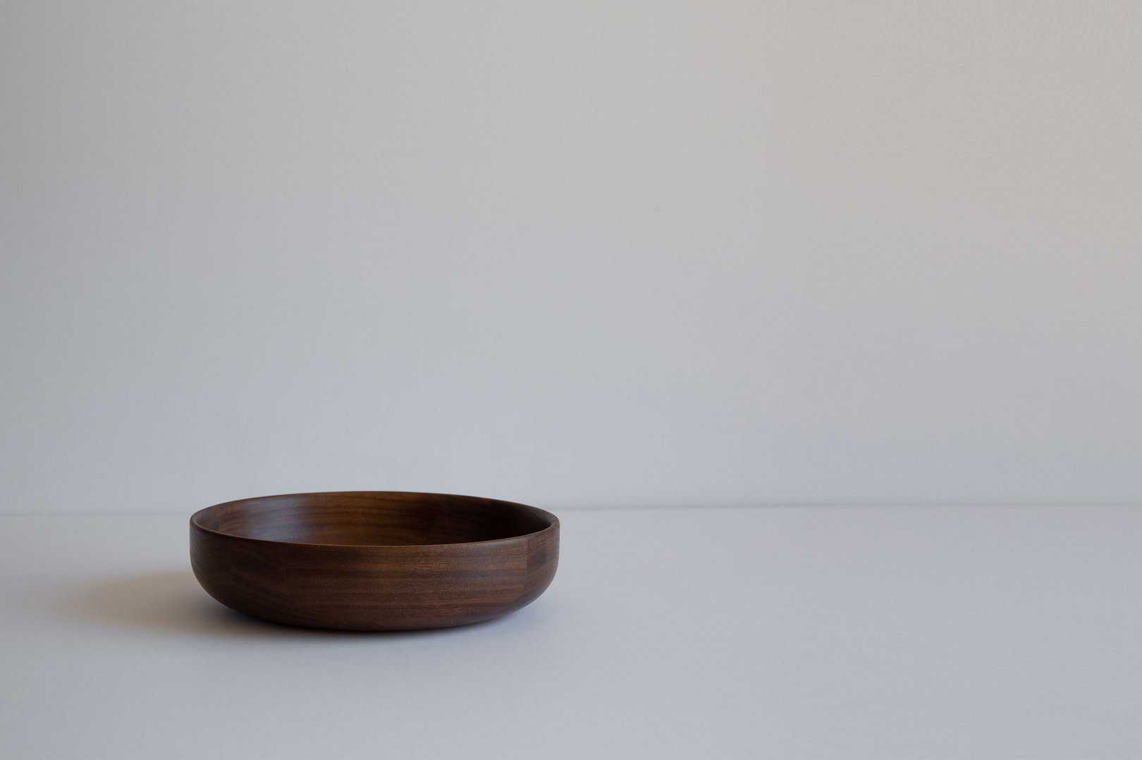 8bowl walnut fullbleed 8 inch Roasted Bowl in Dark toned Wood Empty with a Low Wide Profile on a White Studio Backdrop