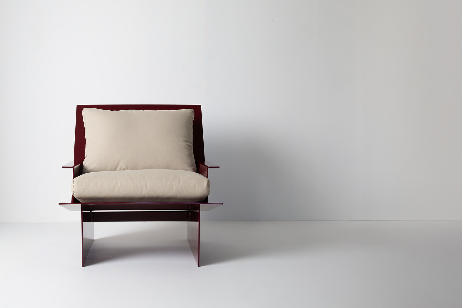 Material Studies Rugosa Chair Oxblood Material Studies I Chair in Oxblood Aluminum with Oatmeal Cushions Straight Front View White Studio