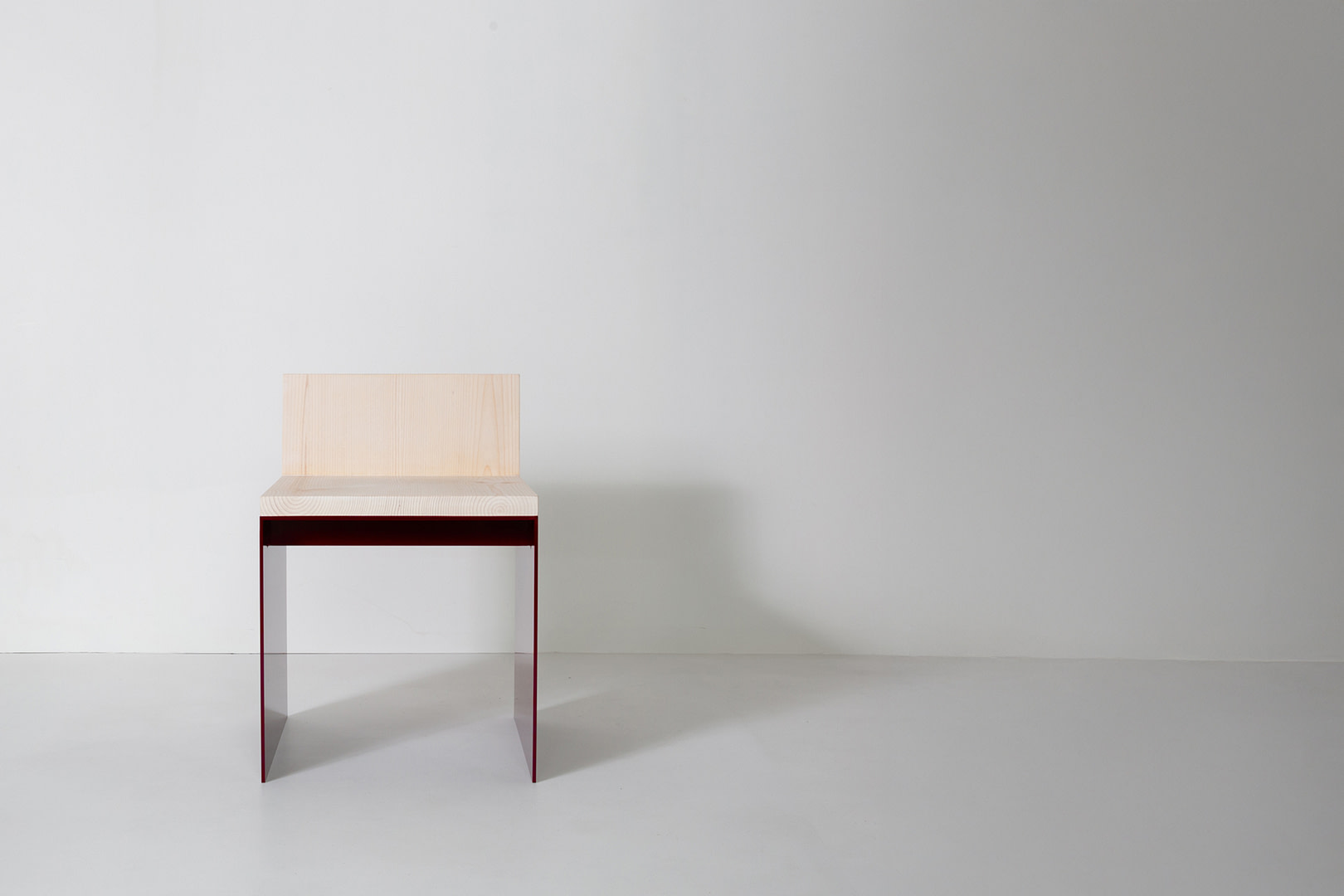 Material Studies I Dining Chair, oxblood aluminum panel legs and sugar pine seat, straight-on front view