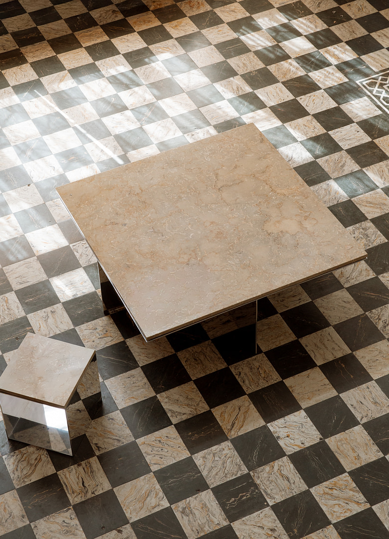 Homepage material studies ii aluminum marble quartzite kalon studios 10 Beige Marble topped Glass Coffee Table on a Black and white Checkerboard Floor with a Small Matching Pedestal Nearby