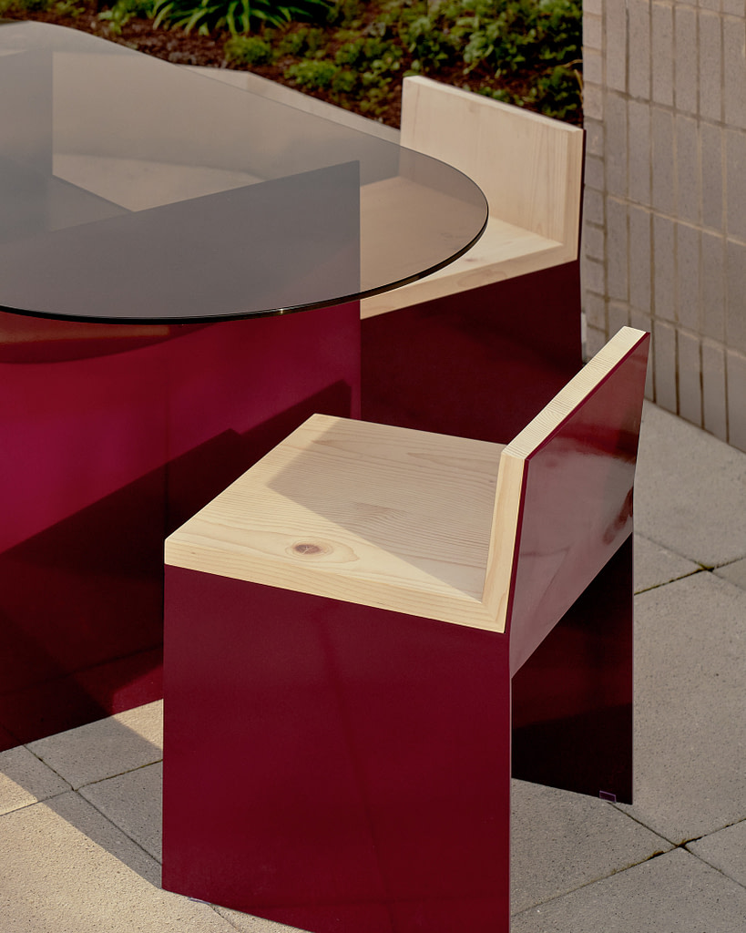 Kalon Material Studies I Aluminum Outdoor Furniture Material Studies I Dining Table in Oxblood with Matching Dining Chairs Close on a Terrace