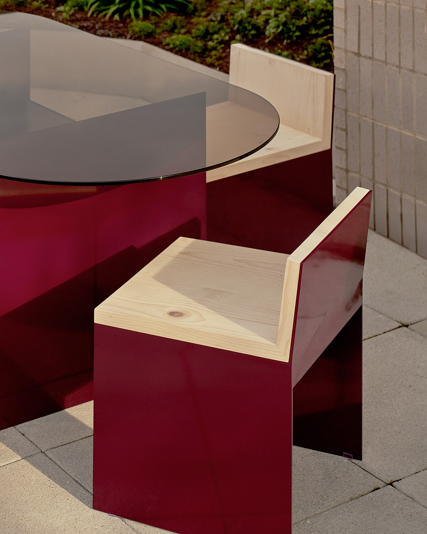 Kalon Material Studies I Aluminum Outdoor Furniture Material Studies I Dining Table in Oxblood with Matching Dining Chairs Close on a Terrace
